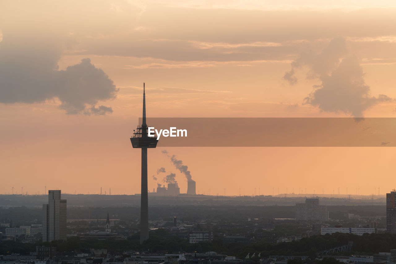 SILHOUETTE OF BUILDINGS AGAINST CLOUDY SKY