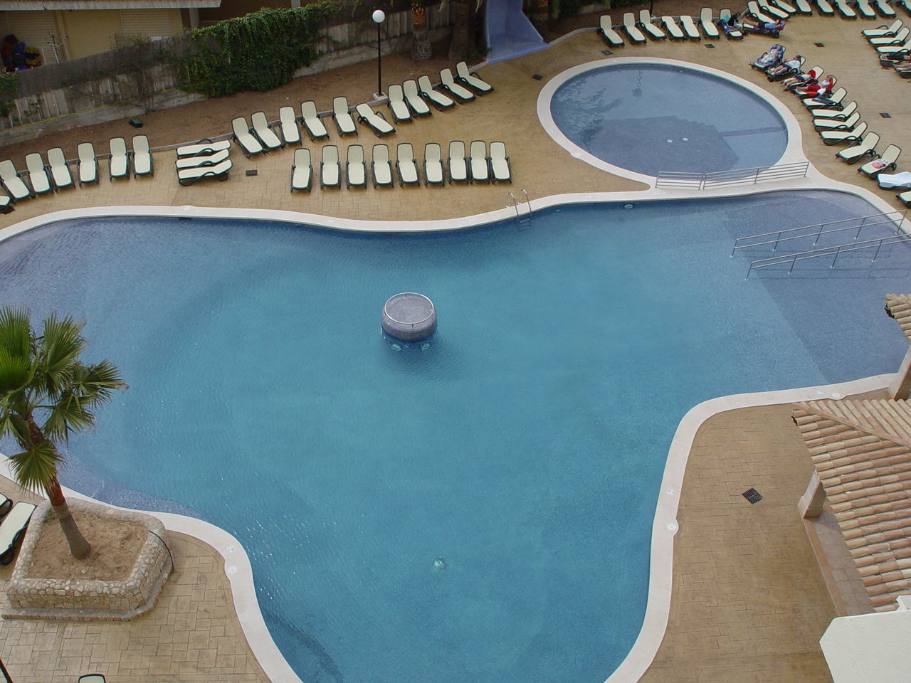 HIGH ANGLE VIEW OF SWIMMING POOL IN FOREGROUND