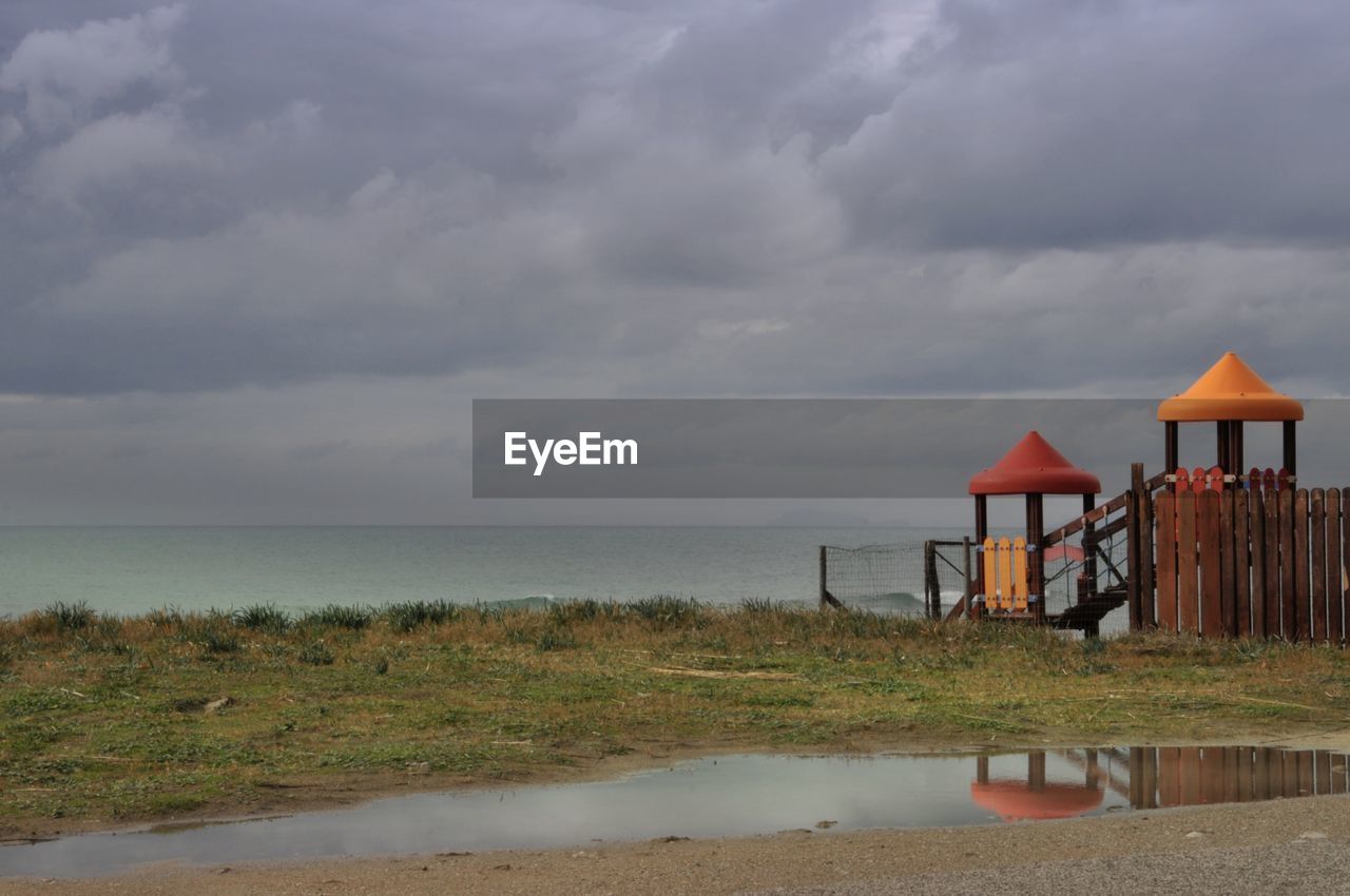 GAZEBO ON BEACH AGAINST SKY