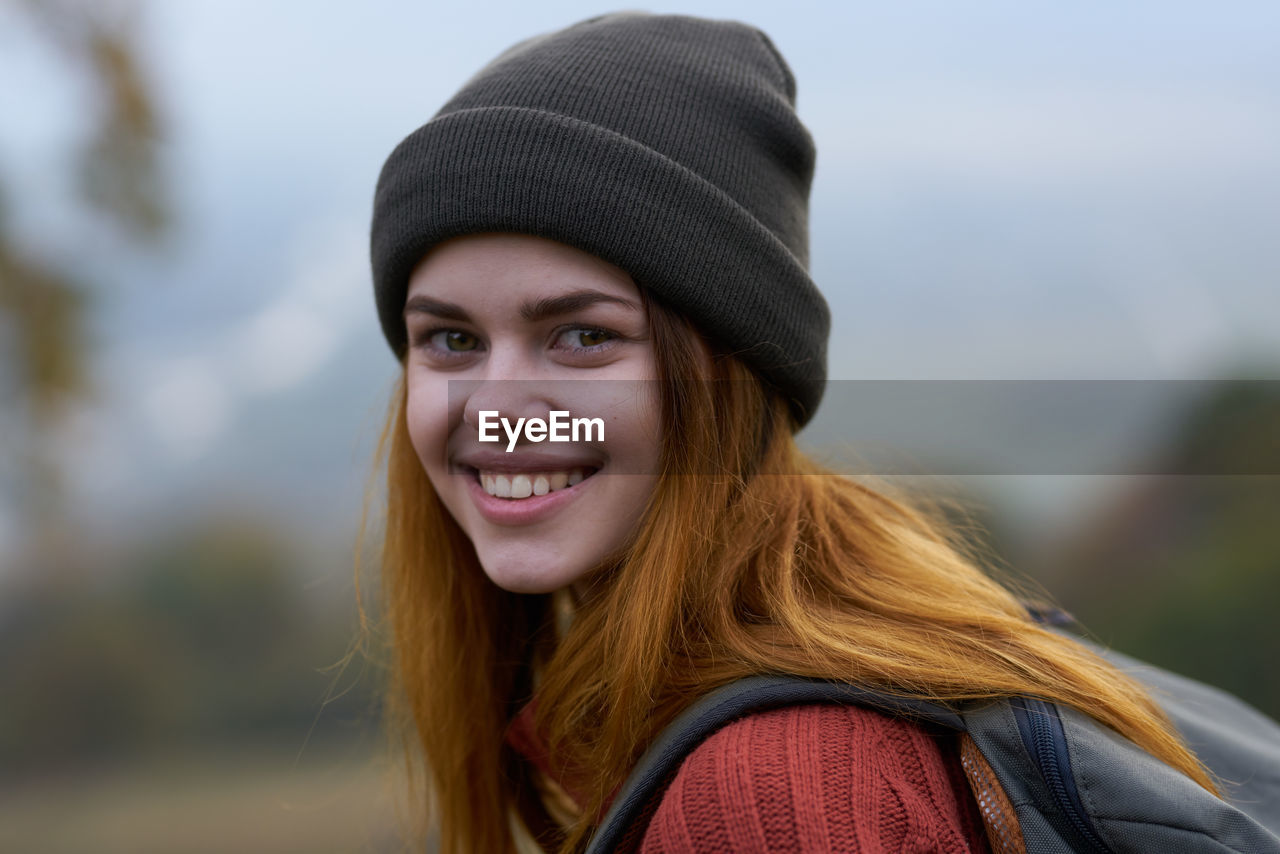 Portrait of smiling young woman in park during winter