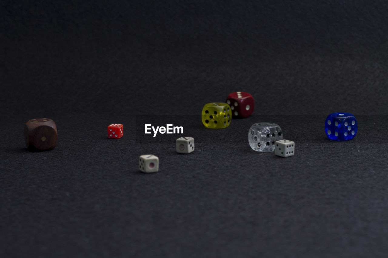 Close-up of colorful dice on black table