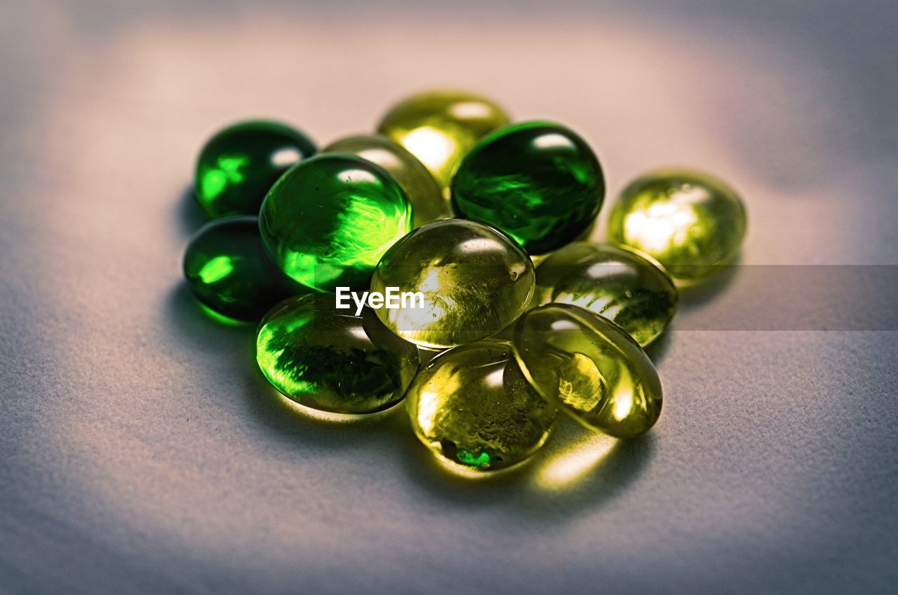 Close-up of green gemstones on table