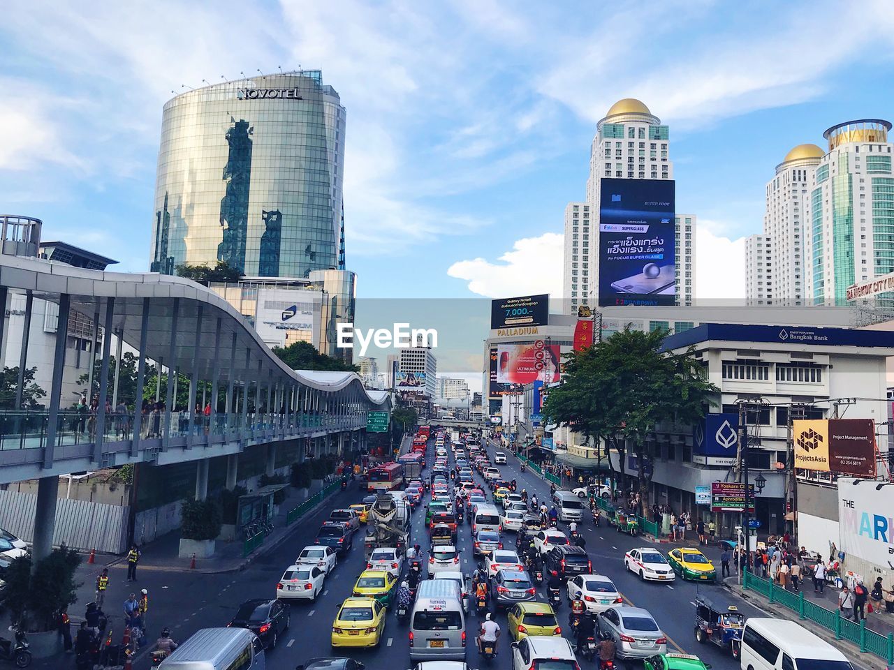 Traffic on road in city against sky