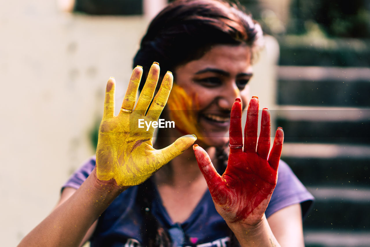 Close-up of smiling woman covered with powder paint