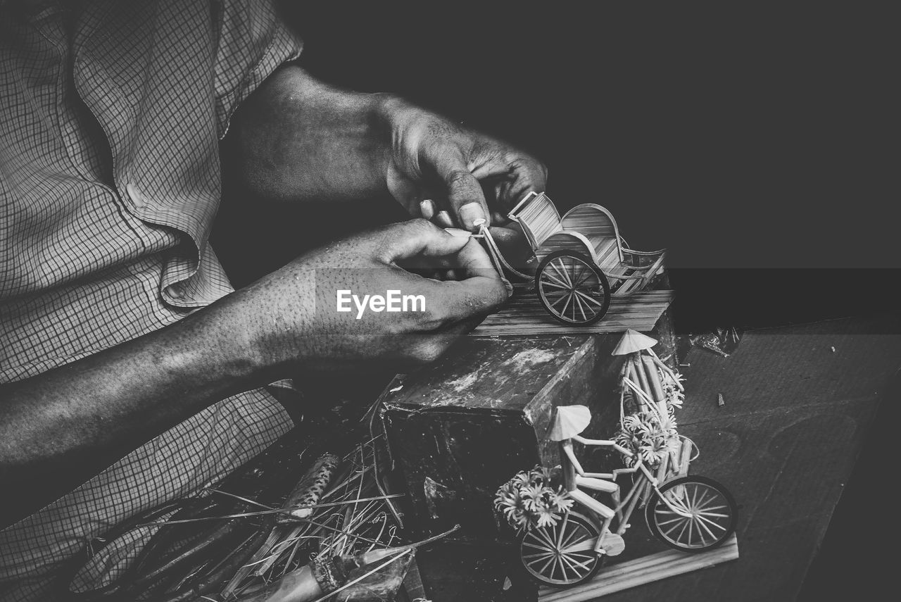 CLOSE-UP OF MAN WORKING AT WORKSHOP