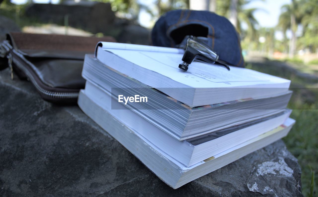 CLOSE-UP OF BOOKS ON TABLE AT TEMPLE