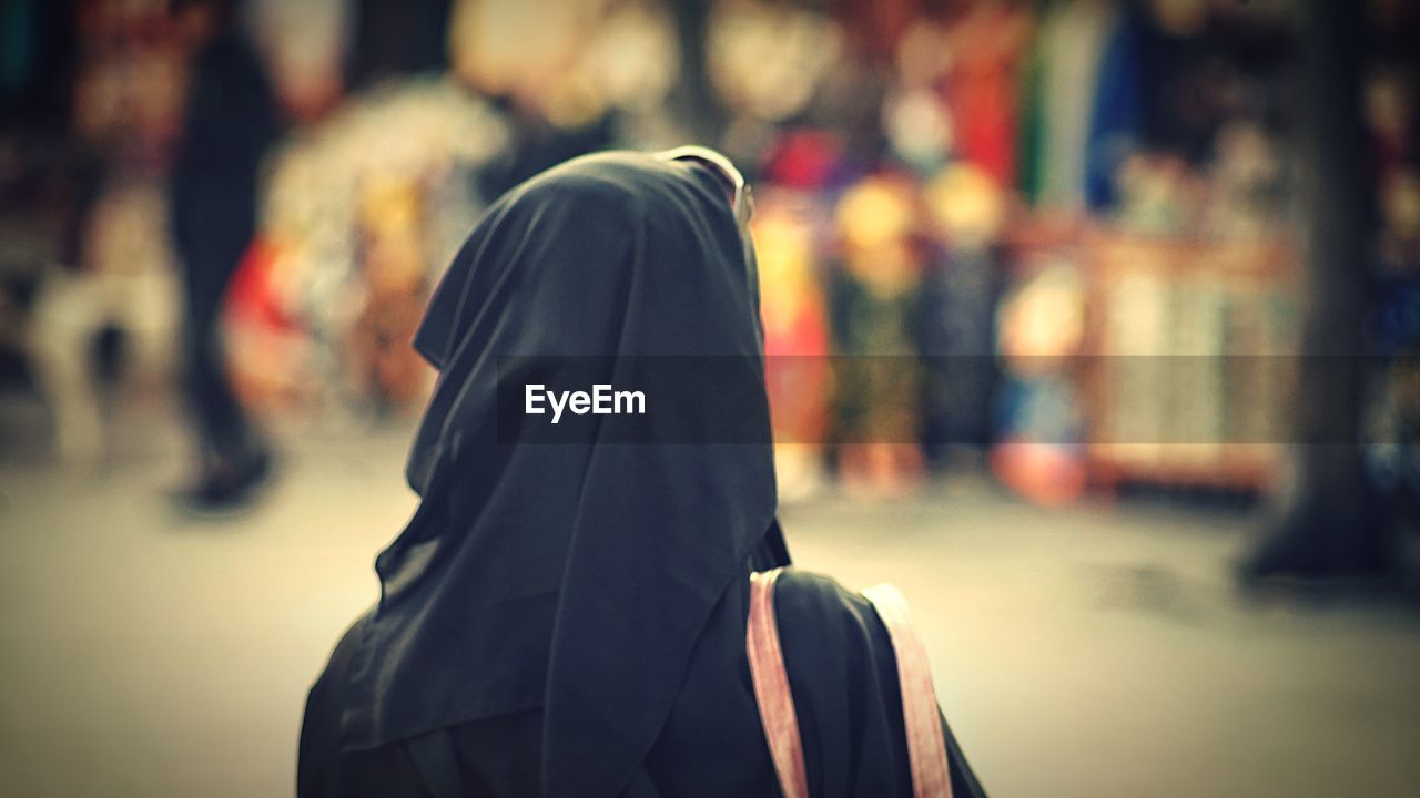 Rear view of woman wearing hijab in city