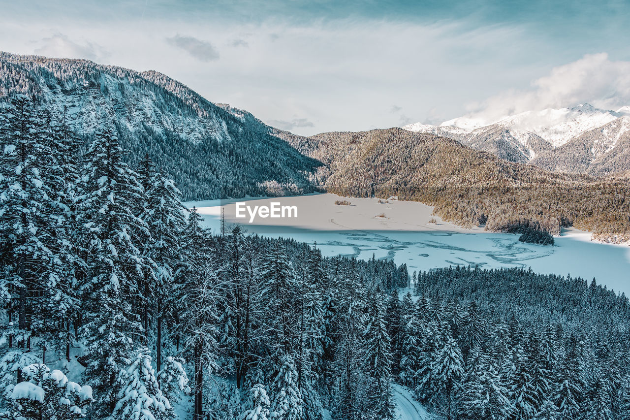 Snowy mountains and trees in the alps. view of the lake eibsee. germany.
