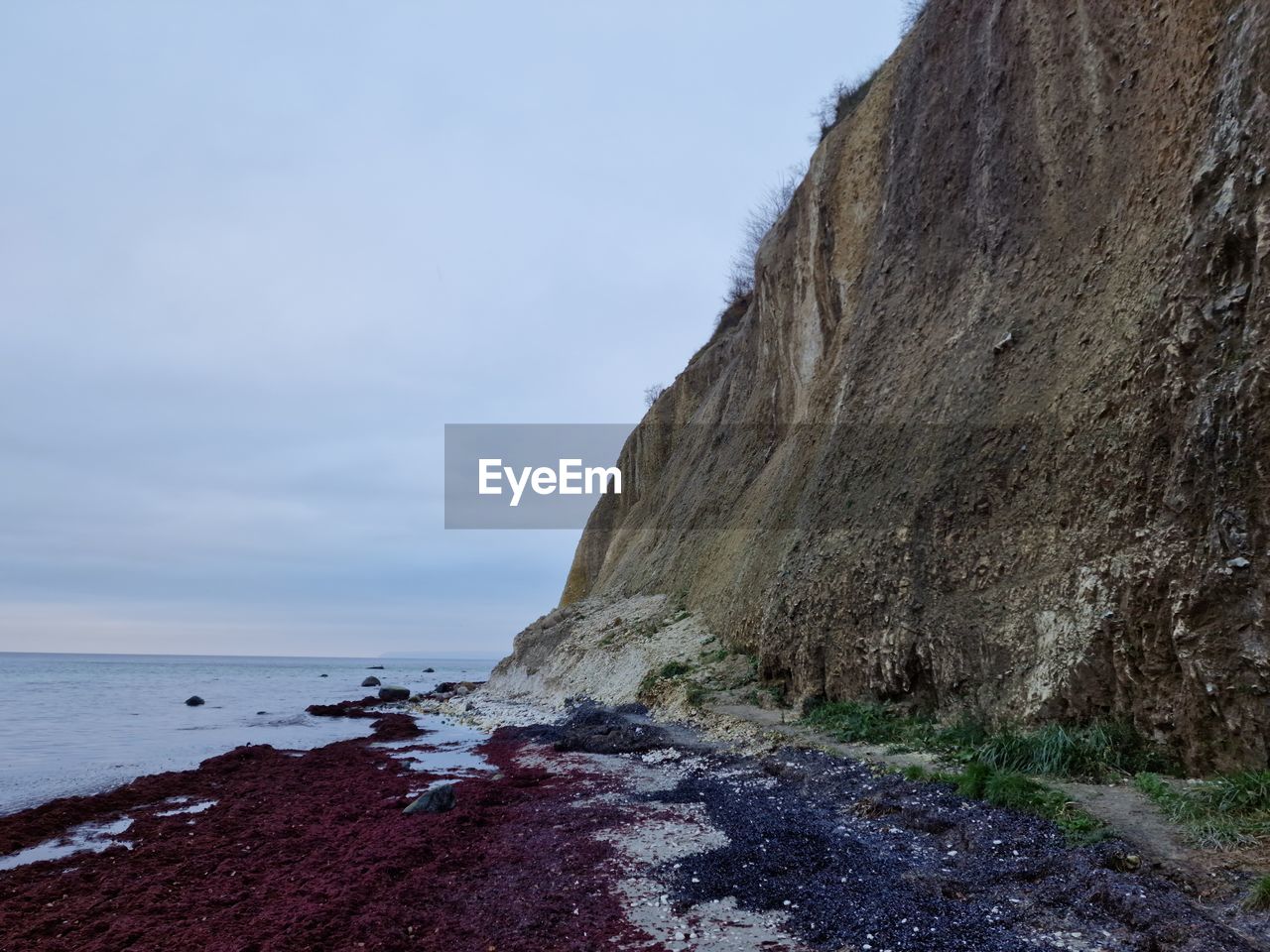 cliff, rock, sea, water, coast, sky, land, beauty in nature, terrain, scenics - nature, beach, nature, ocean, shore, tranquility, tranquil scene, no people, non-urban scene, day, rock formation, body of water, cloud, bay, geology, outdoors, horizon over water, horizon, idyllic, coastline, mountain, travel destinations, environment, wave