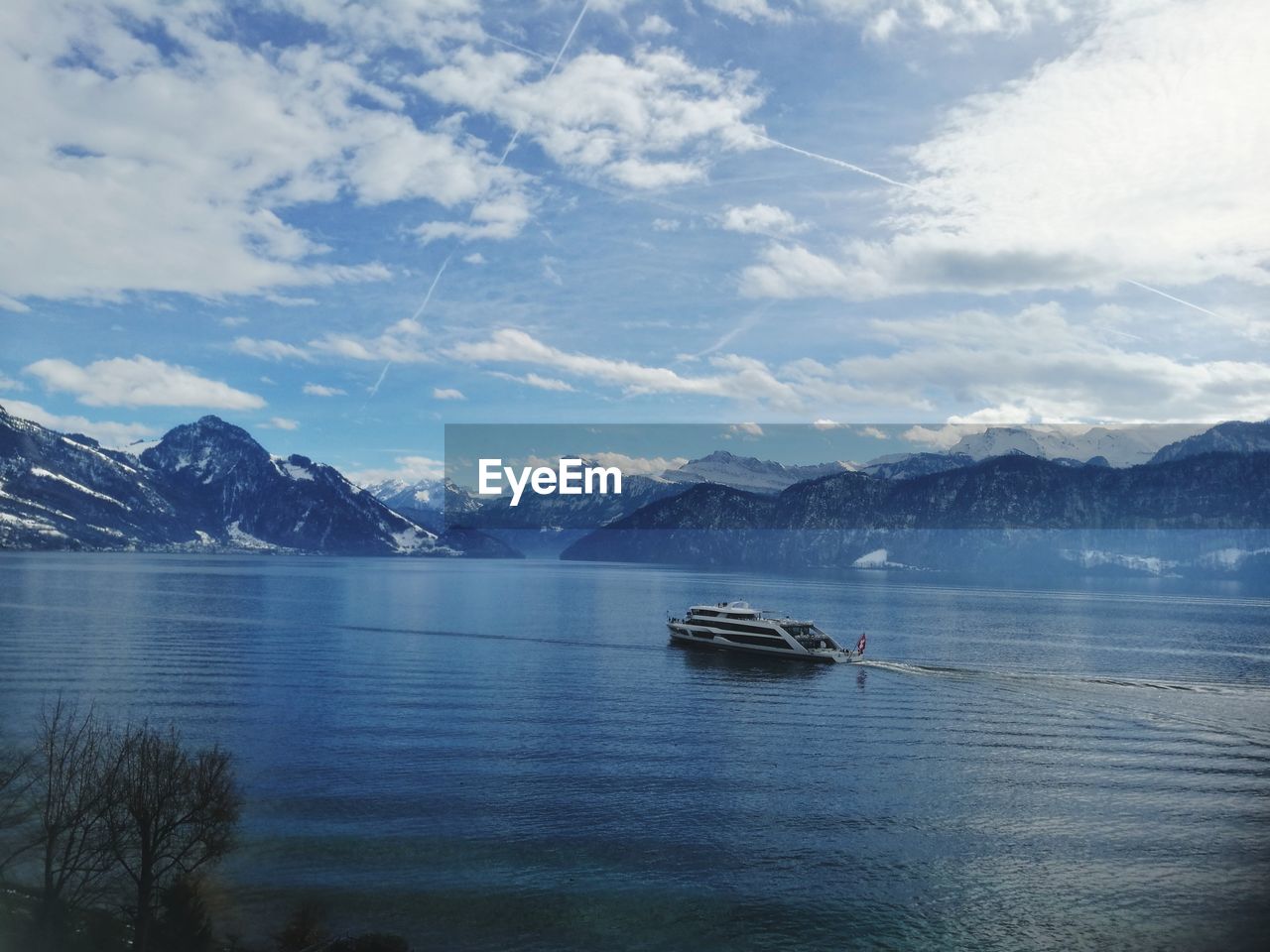 Sailboat in sea against mountains