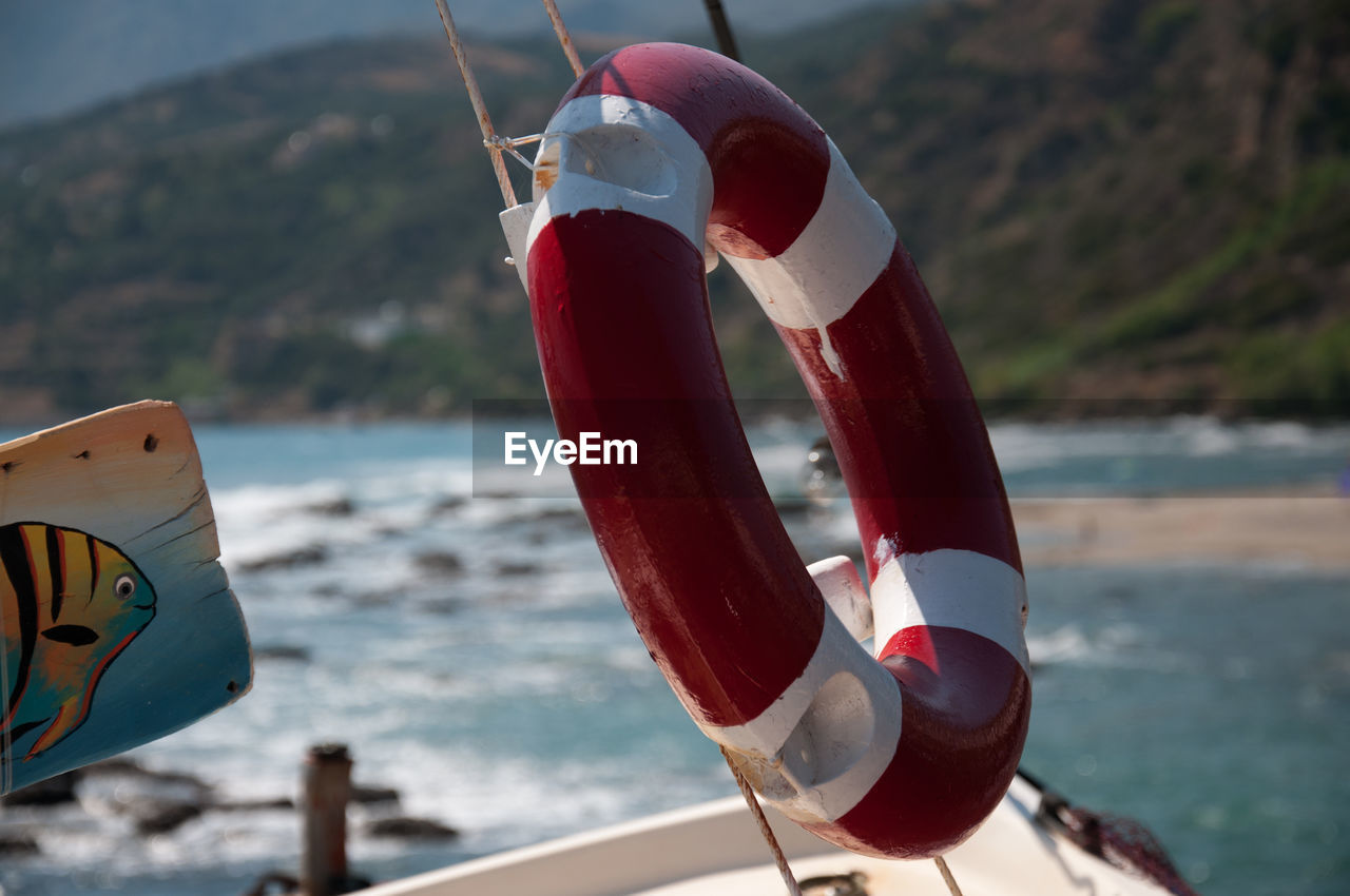 CLOSE-UP OF COIN-OPERATED BINOCULARS ON SEA