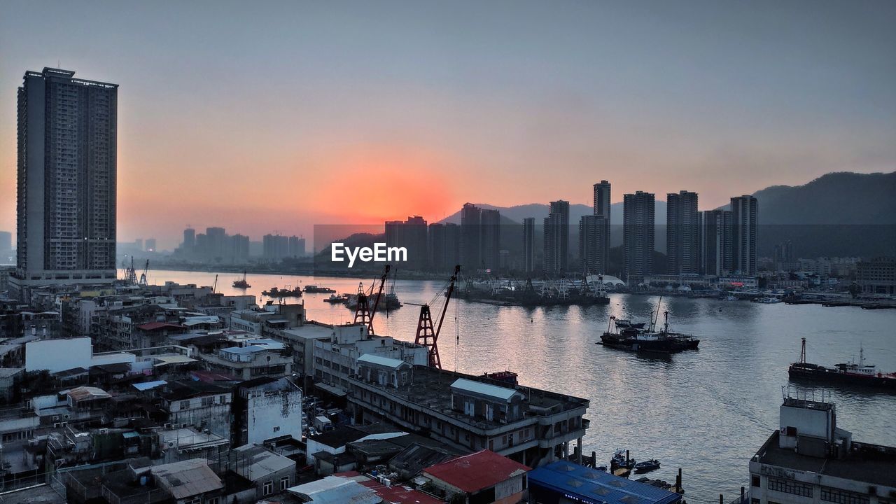 High angle view of bay and buildings against sky