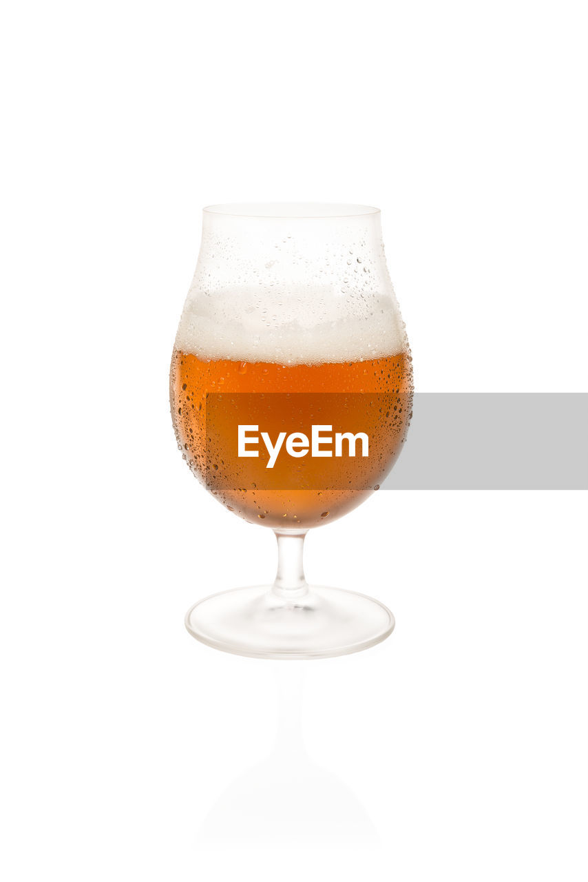 CLOSE-UP OF BEER GLASS ON WHITE BACKGROUND