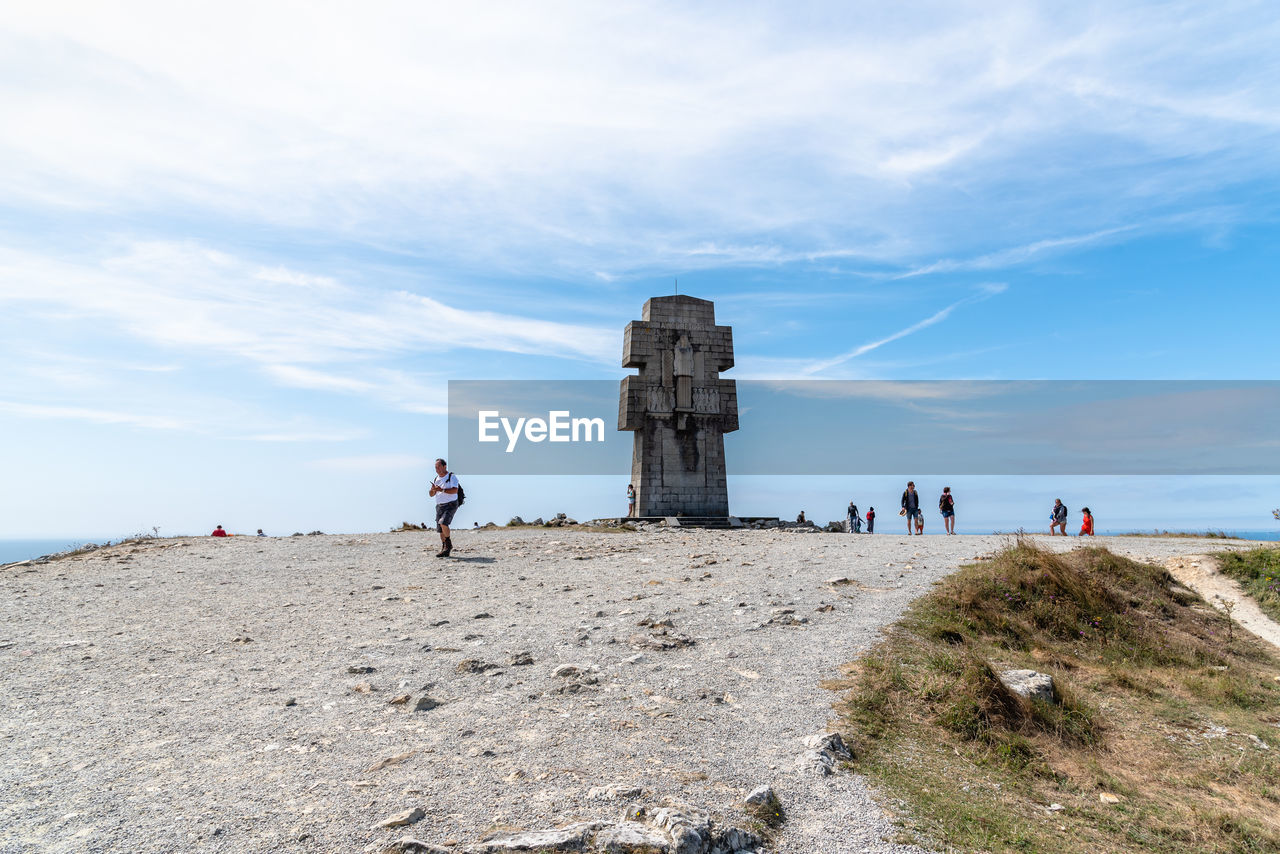 PEOPLE ON BEACH AGAINST CLEAR SKY