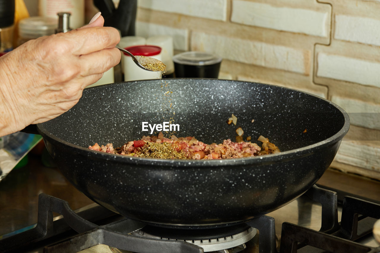 cropped hand of person preparing food