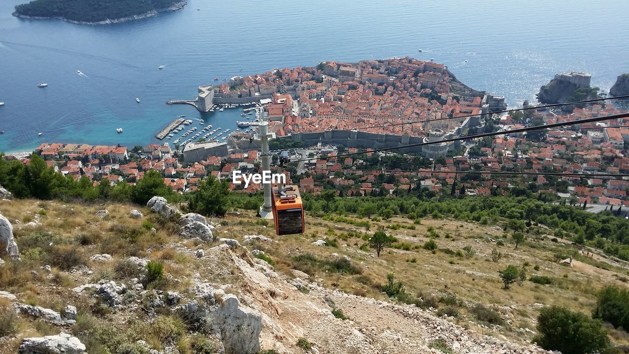 High angle view of cityscape by sea against sky