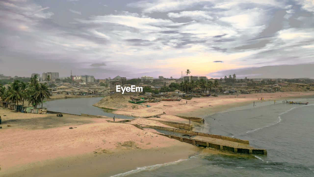 Panoramic view of beach and buildings against sky