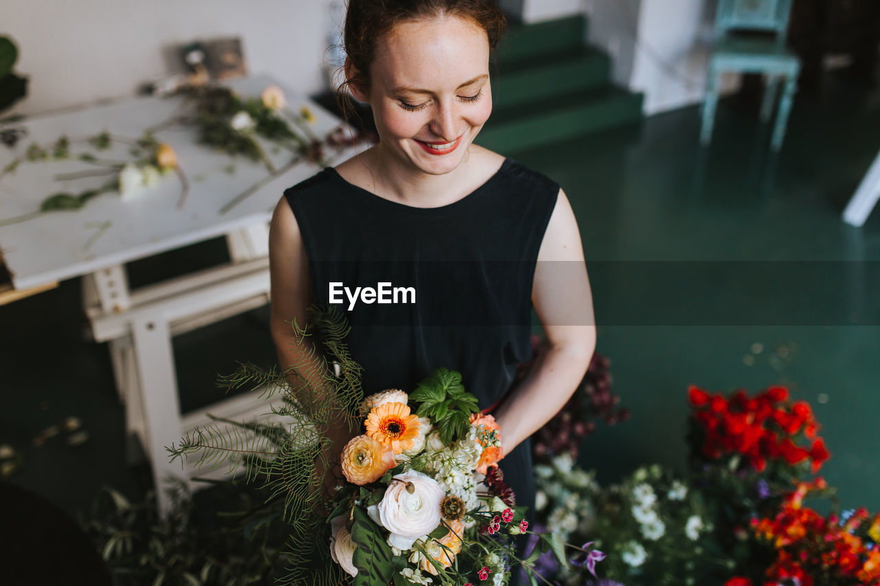 Woman holding flowers at home