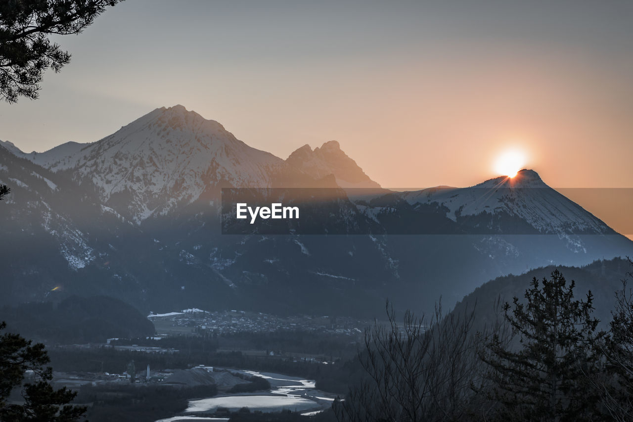 Scenic view of snowcapped mountains against sky during sunset