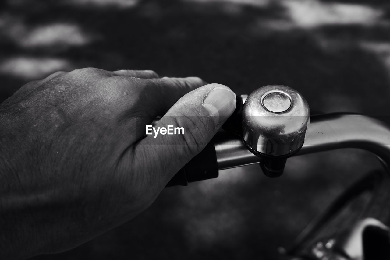 Cropped image of hand ringing bicycle bell