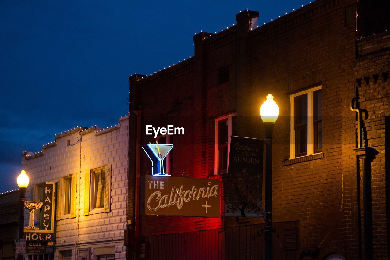 LOW ANGLE VIEW OF ILLUMINATED BUILDING