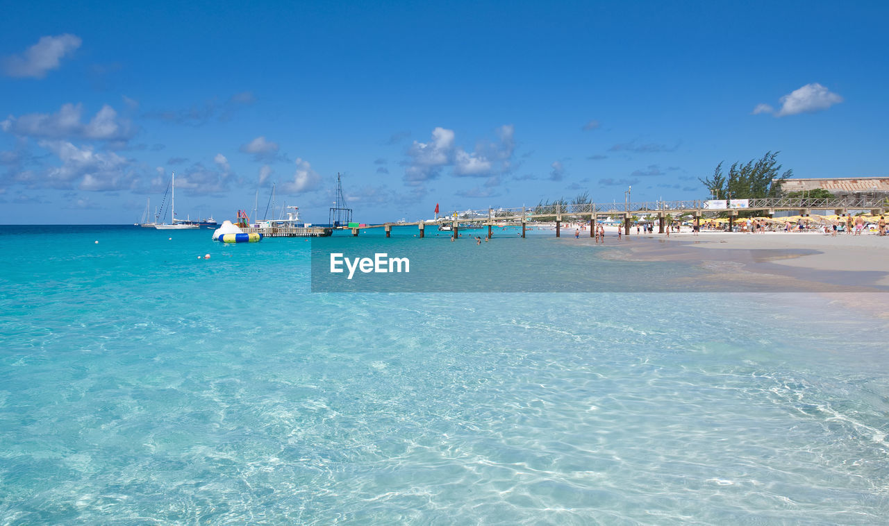 Scenic view of beach against blue sky
