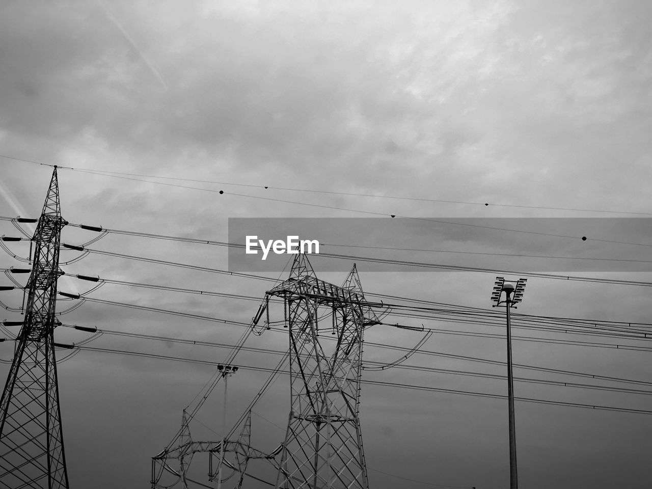 Low angle view of electricity pylon against sky