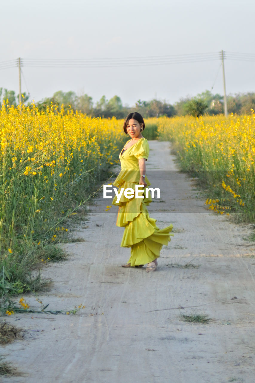 Portrait of woman standing on field