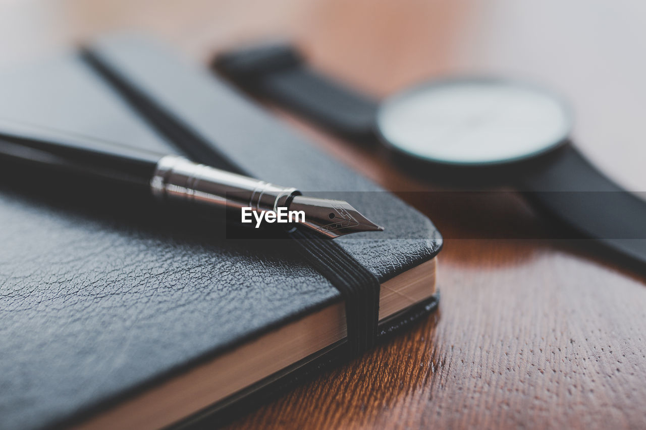 High angle view of pen and book on table