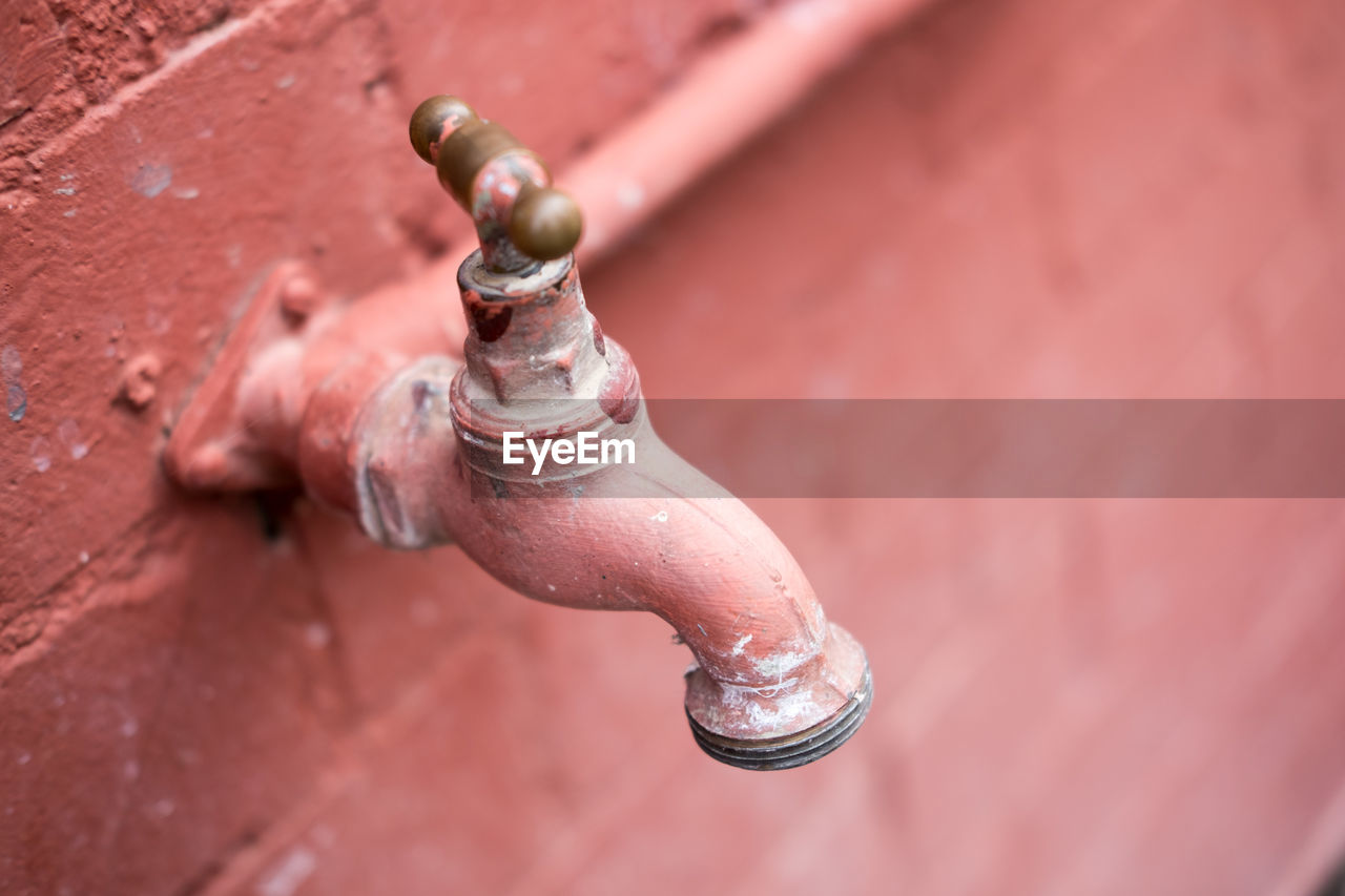 Close-up of faucet mounted on wall