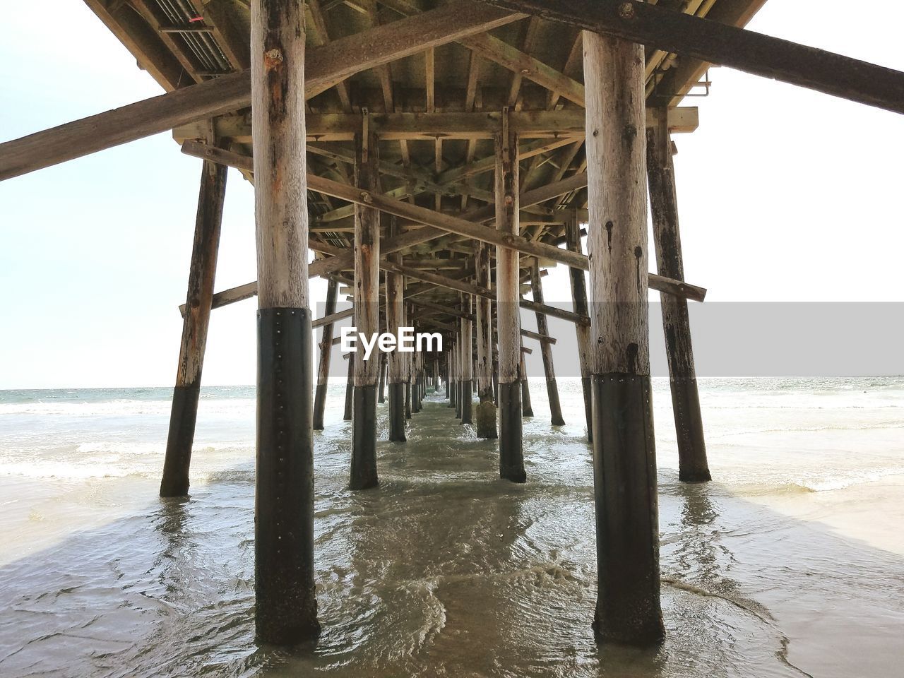 Low angle view of wooden pier on sea 