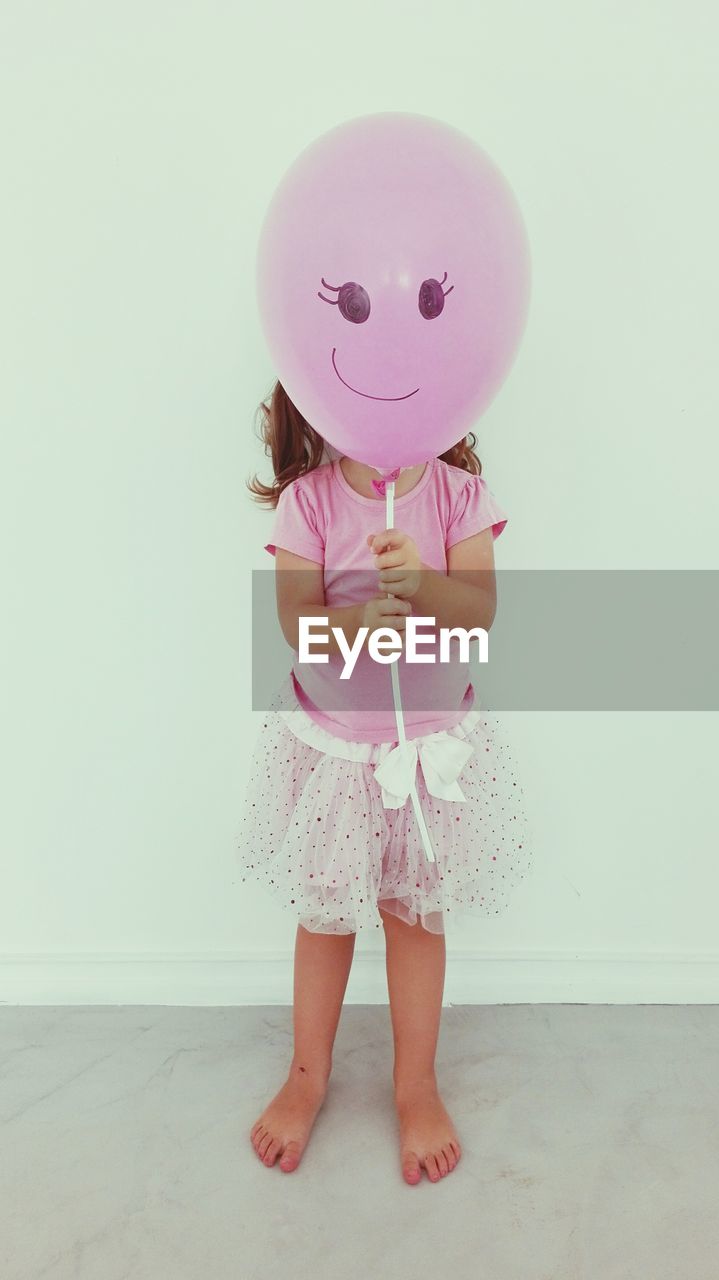 Cute girl holding balloon