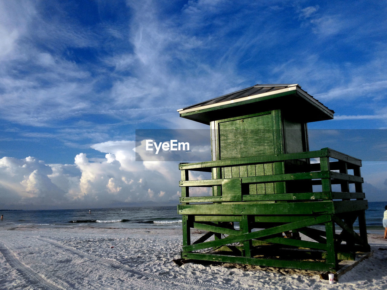 sky, cloud, beach, land, nature, water, architecture, hut, sea, built structure, scenics - nature, no people, ocean, lifeguard hut, beauty in nature, man made structure, environment, blue, landscape, tower, travel destinations, outdoors, tranquility, day, building exterior, tranquil scene, coast, sand, wood, security, protection, building, travel, shore, snow