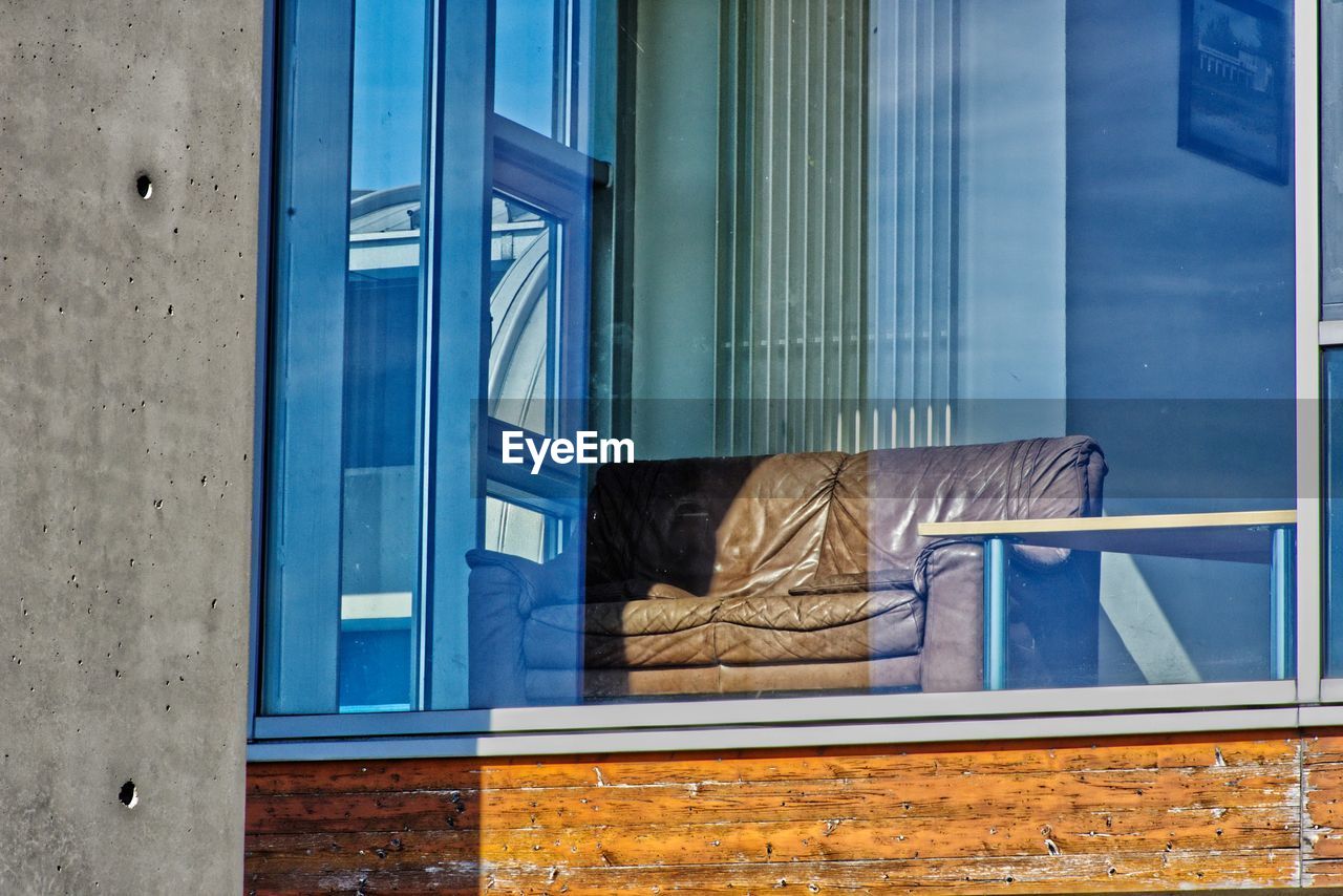 REAR VIEW OF WOMAN SEEN THROUGH WINDOW