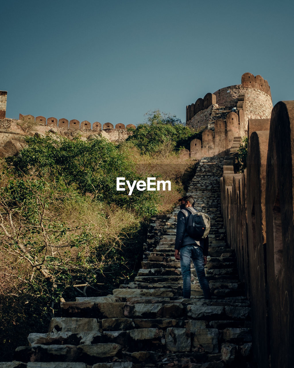 Full length of man on old wall against clear sky