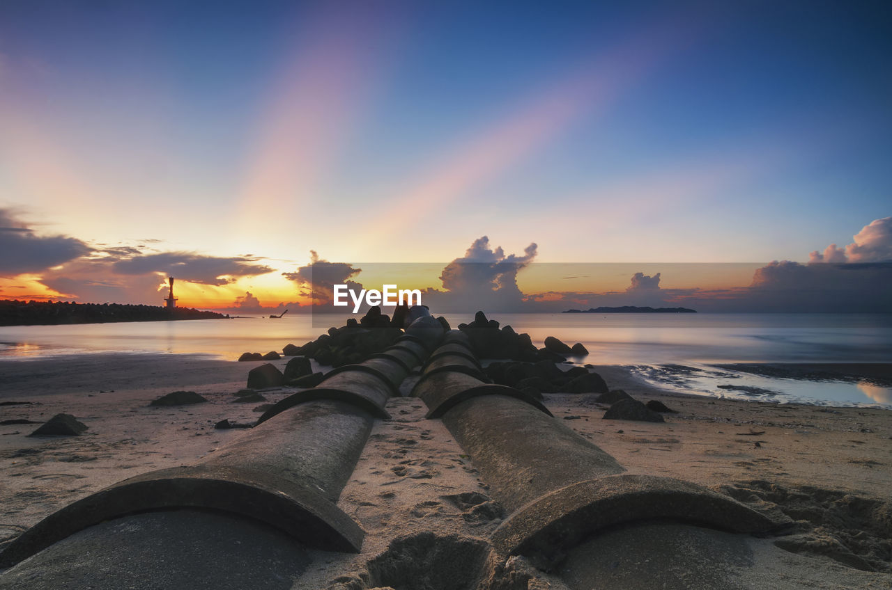 Scenic view of beach against sky during sunset