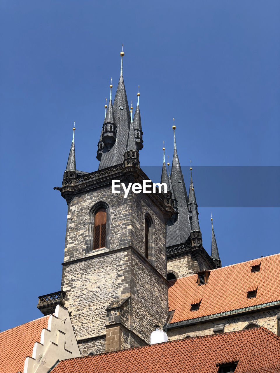 Low angle view of church of our lady before tyn in prague under clear blue sky