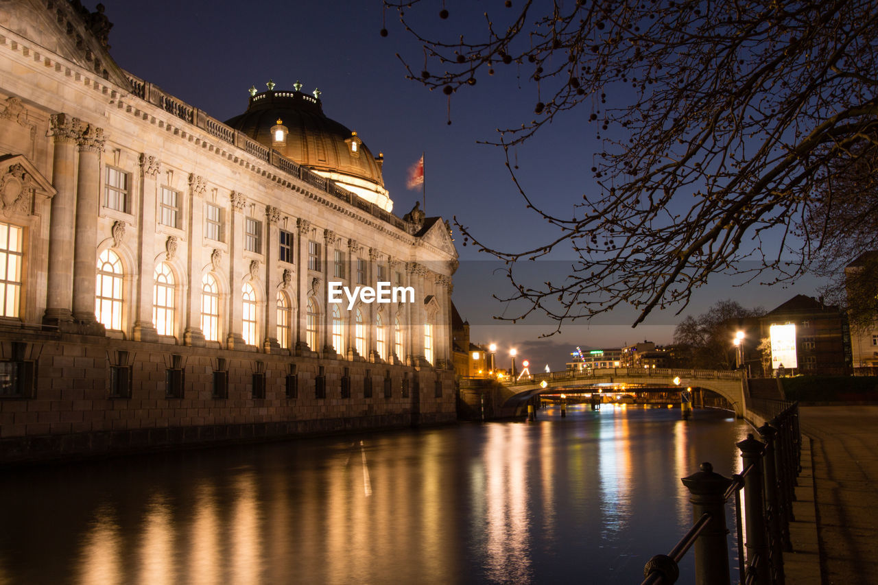 River by bode museum in illuminated city at night