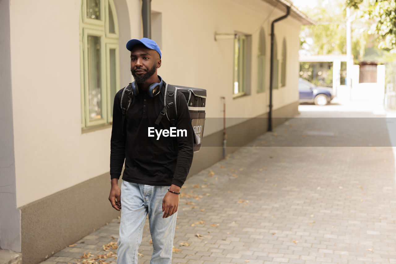 full length of young man standing on street