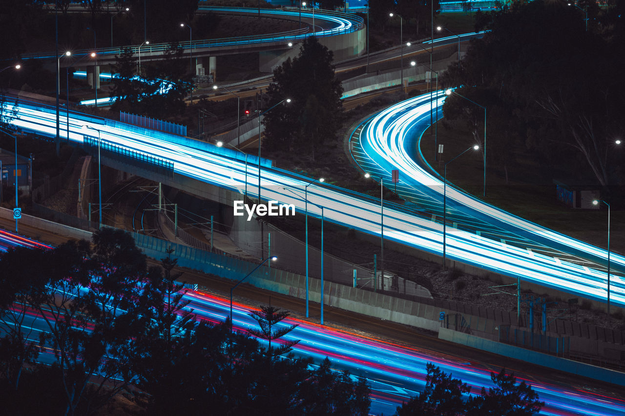 HIGH ANGLE VIEW OF LIGHT TRAILS ON ROAD IN CITY