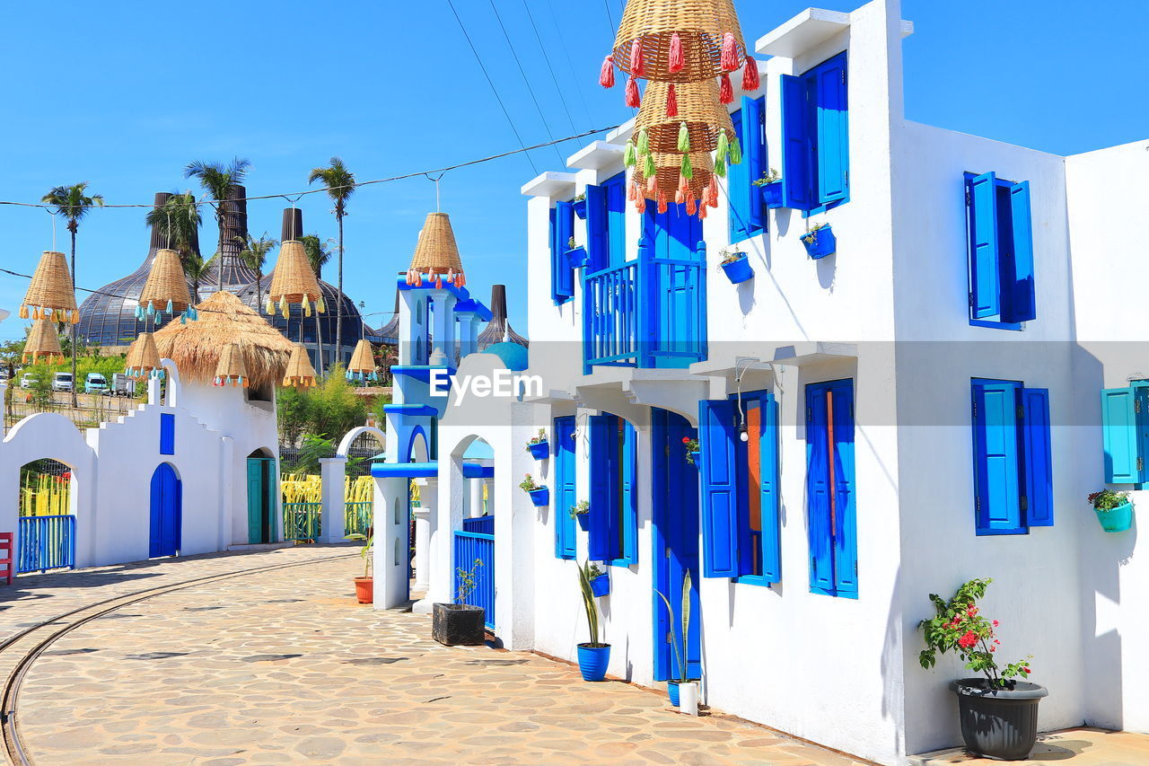 Row of multi colored buildings against blue sky