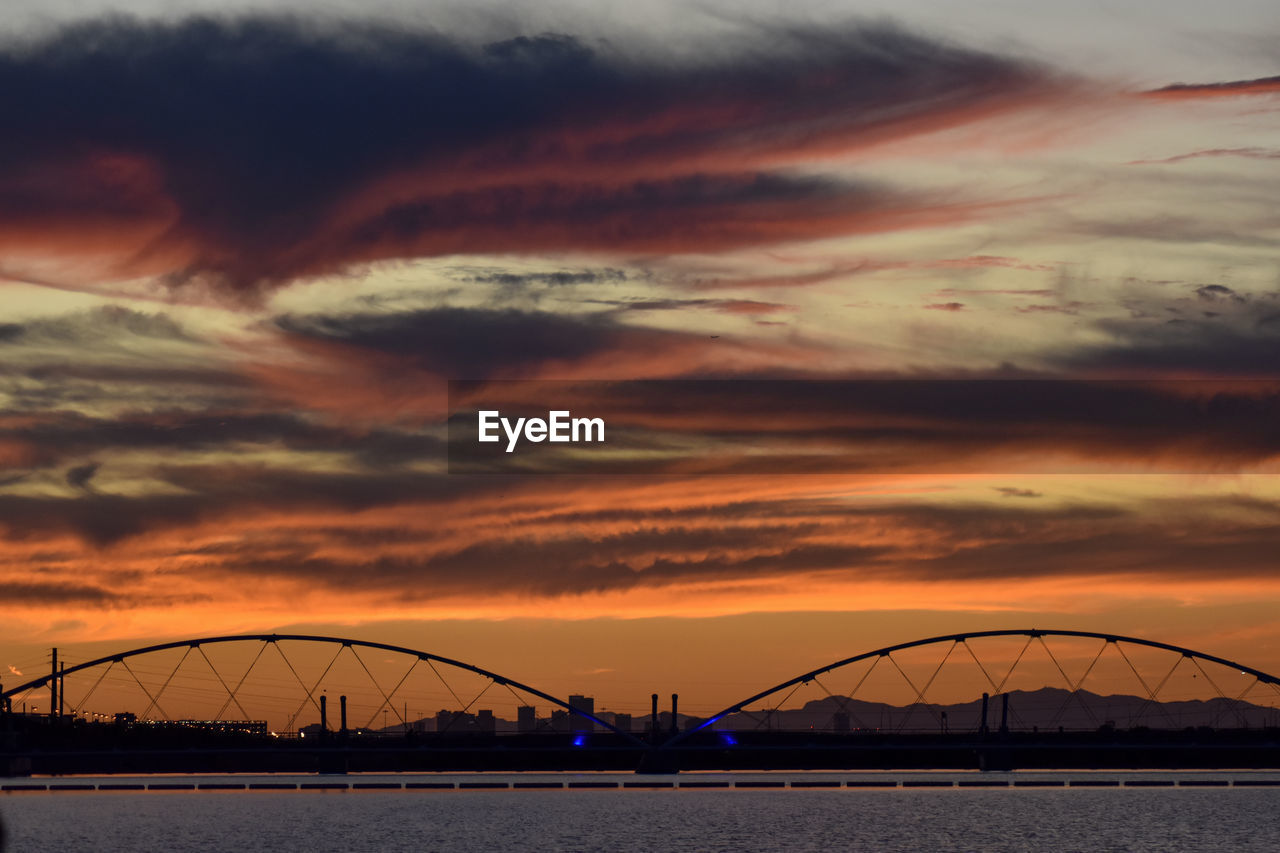 SILHOUETTE BRIDGE AGAINST SKY AT DUSK