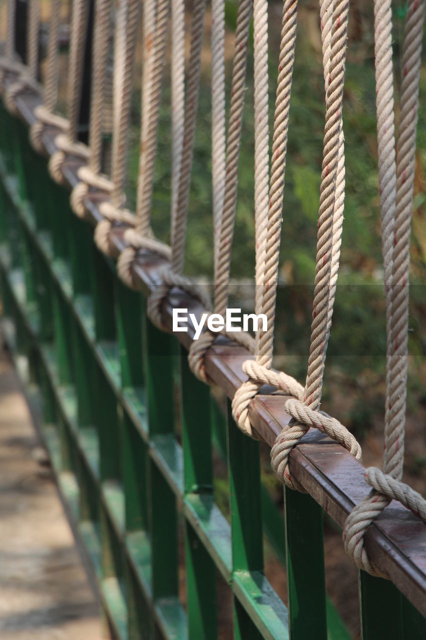 Close-up of rope tied to railing