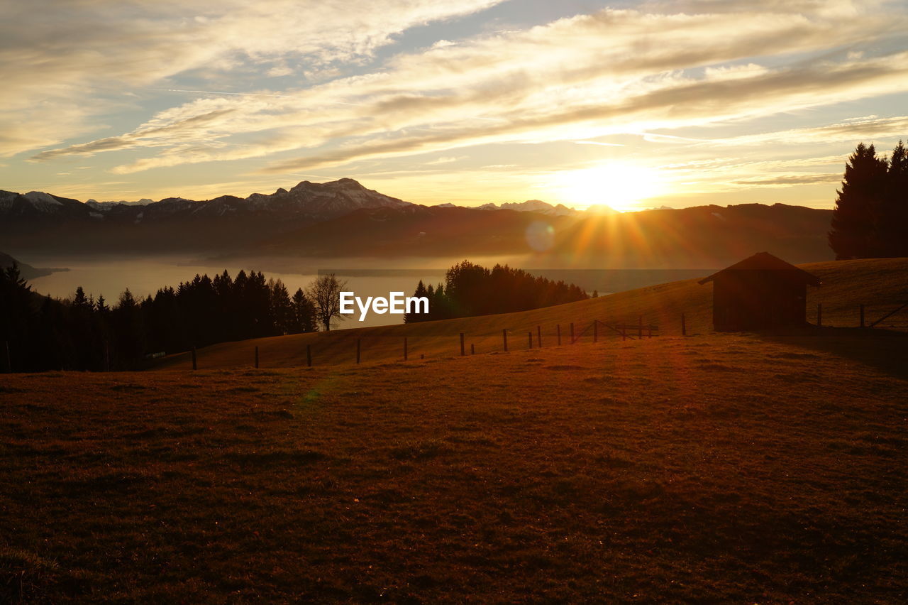 Scenic view of landscape against sky during sunset