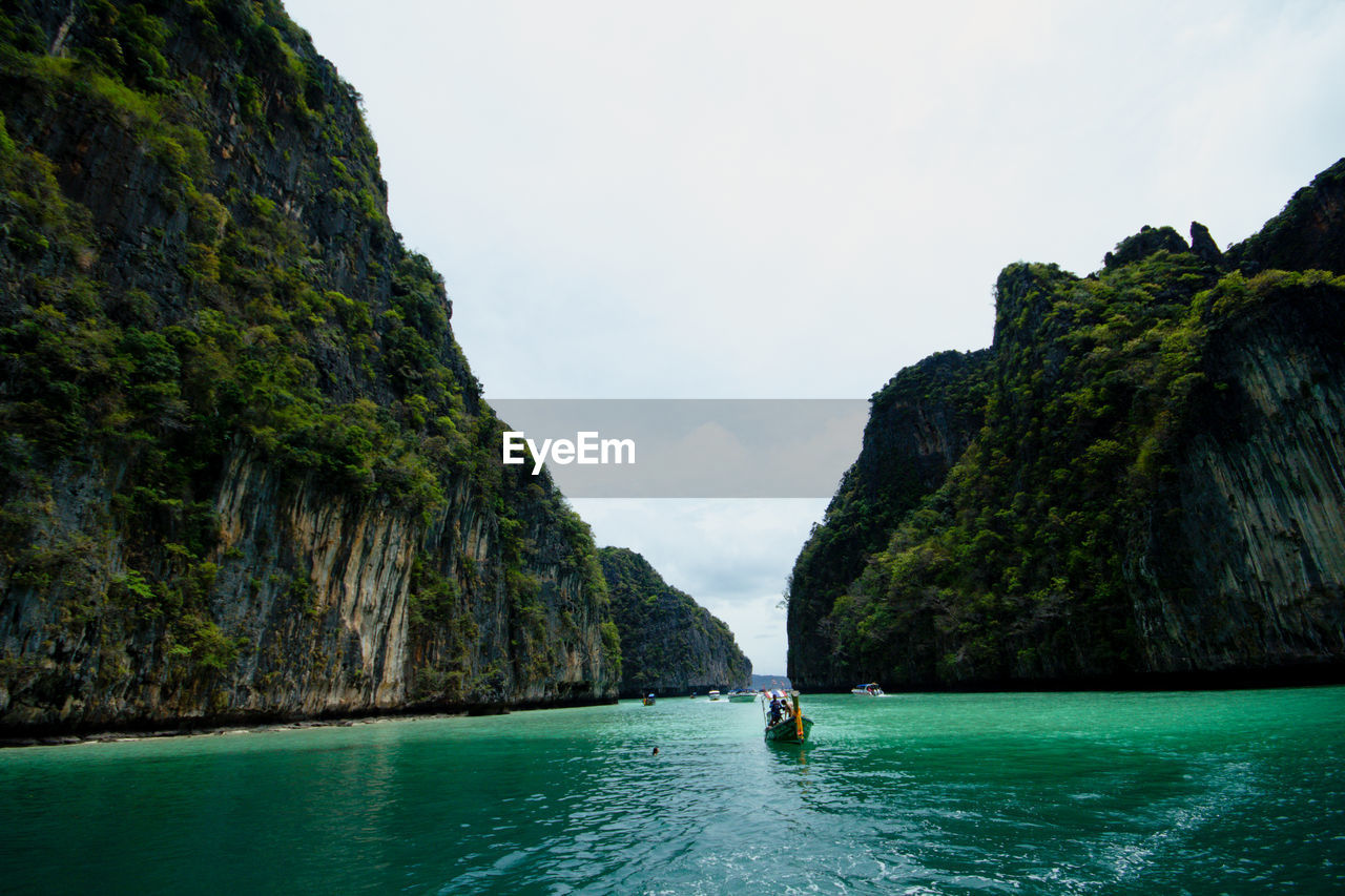 Scenic view of sea and mountains against sky