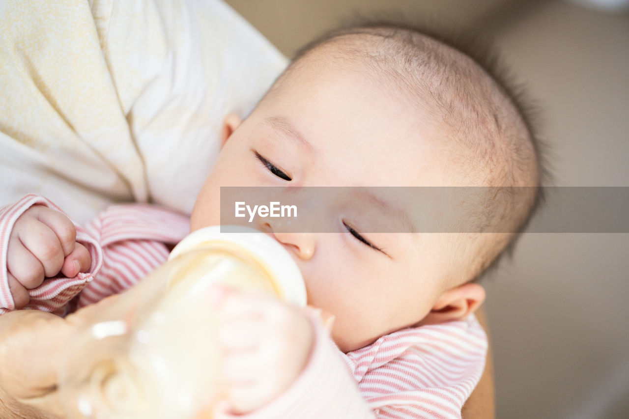 CLOSE-UP OF CUTE BABY SLEEPING IN BEDROOM