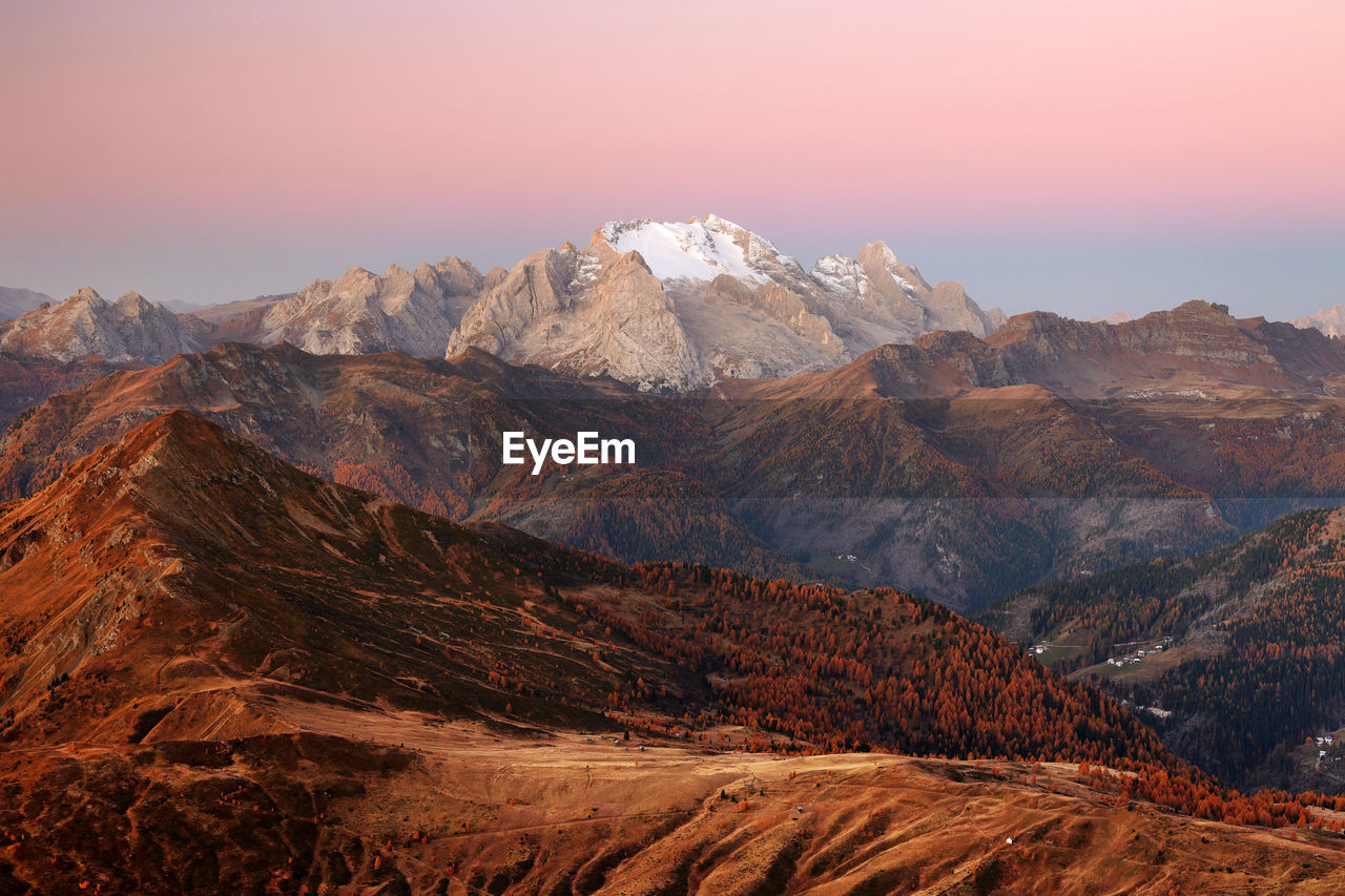 Scenic view of arid landscape against sky during sunset