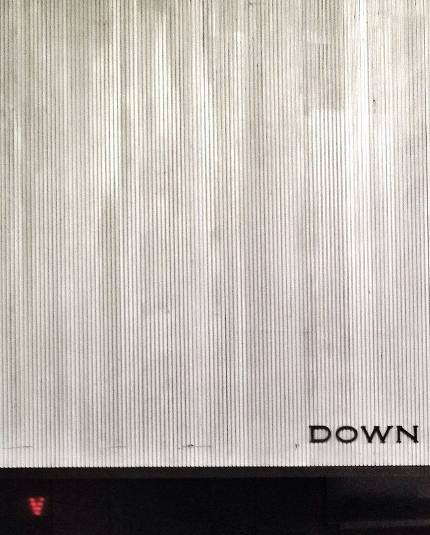 Metal wall with down sign