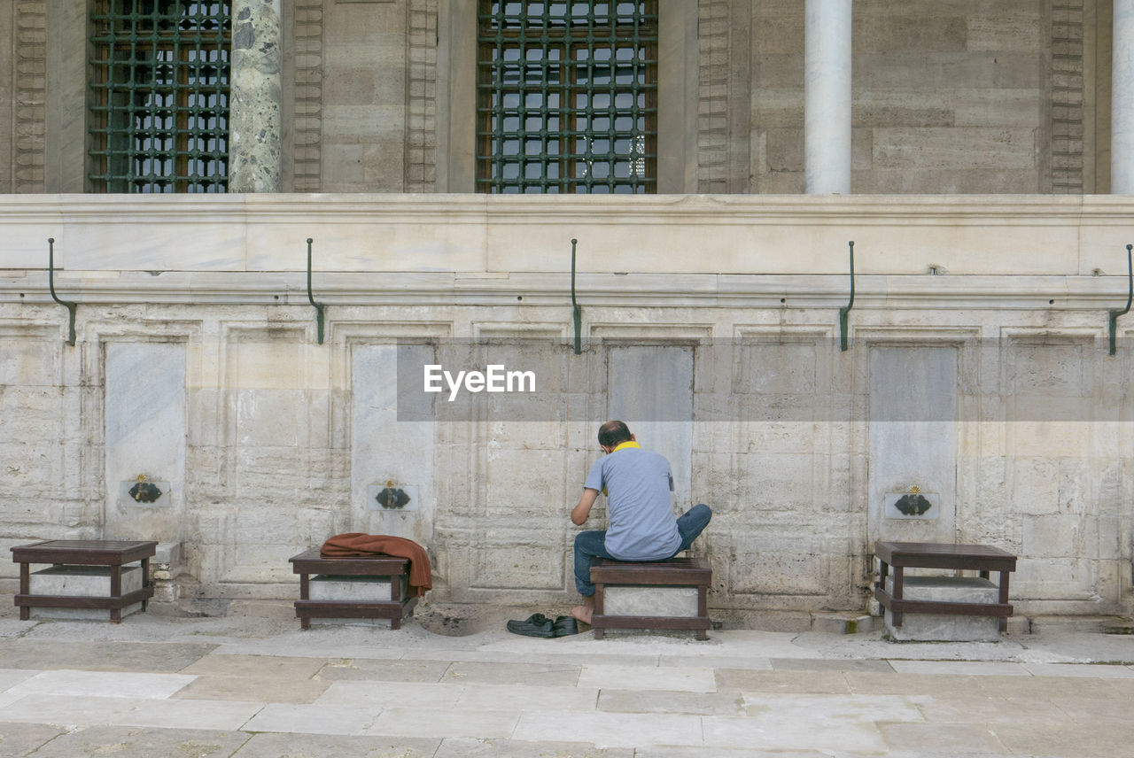 Unidentified muslim man takes ablution before a prayer at suleimaniye mosque in istanbul, turkey.