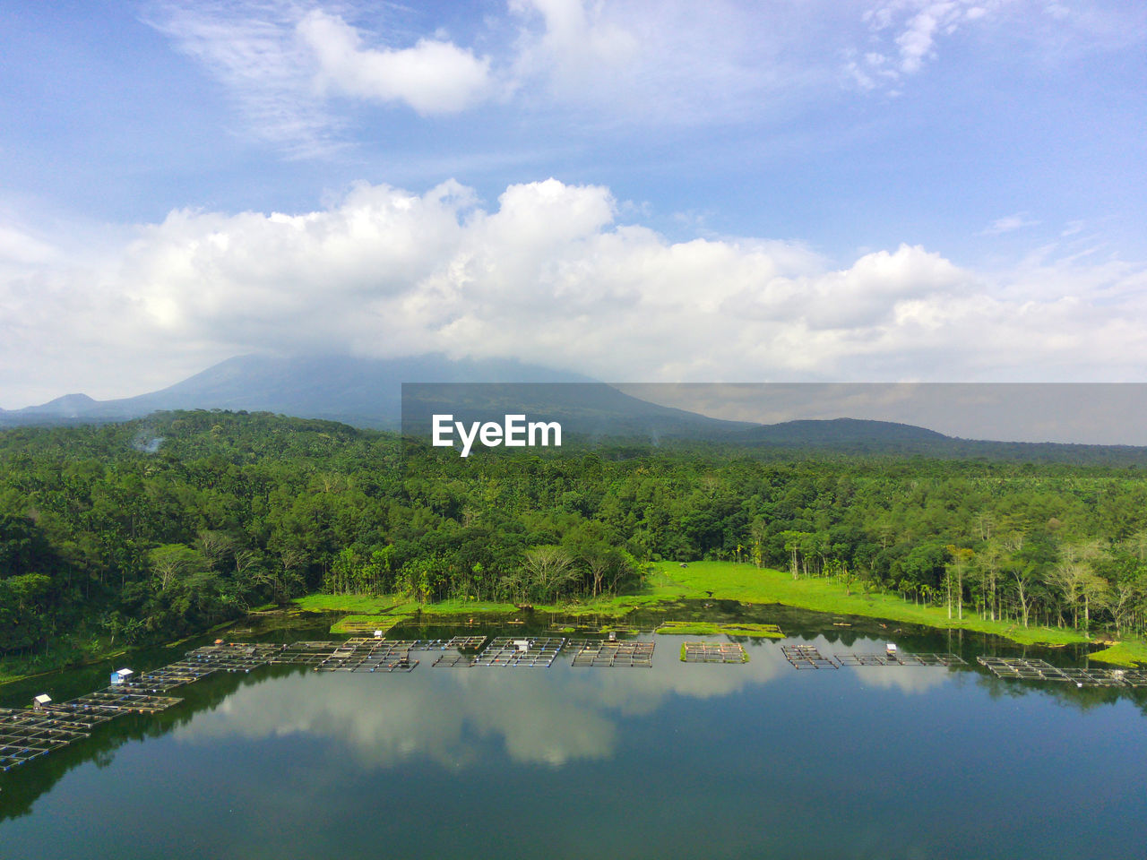 Aerial view of the lake with mountain covered by the clouds